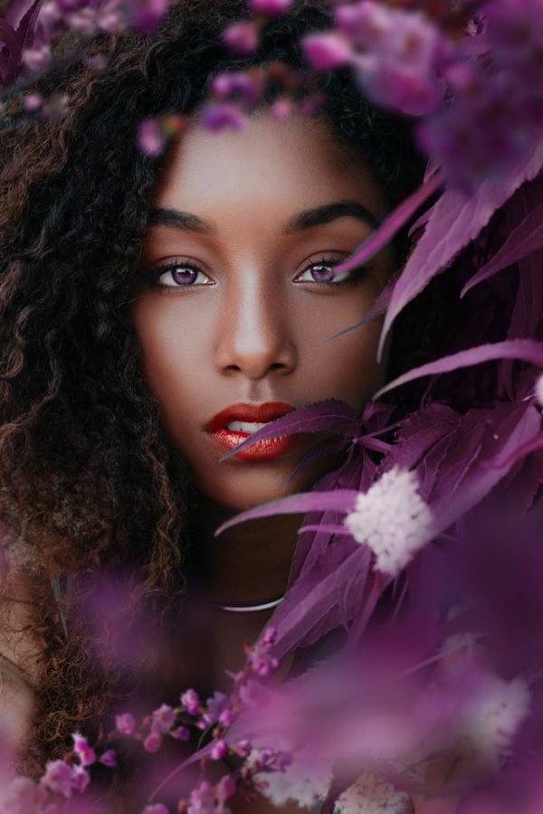 Close-up Photo of Woman near Violet Flowers